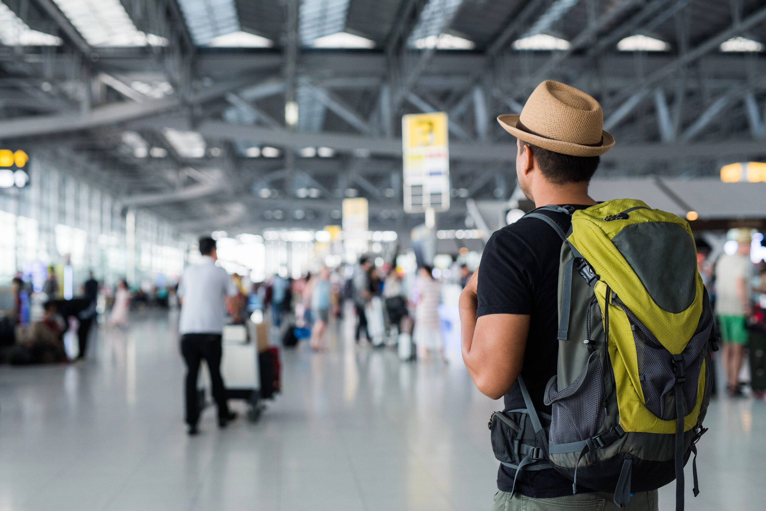 Man at airport with travel backpack